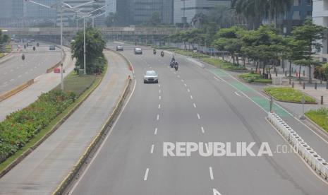 Kendaraan melintas di Jalan Jendral Sudirman yang terlihat sepi pada hari pertama Idul Fitri 1442 H, Jakarta, Kamis (13/5/2021). Pemprov DKI melakukan penyekatan di area perbatasan untuk mengoptimalkan Crowd Free Night Jakarta tadi malam Hal inilah yang menyebabkan warga Jakarta lebih memilih berada di rumah, untuk menghindari penyebaran COVID-19.