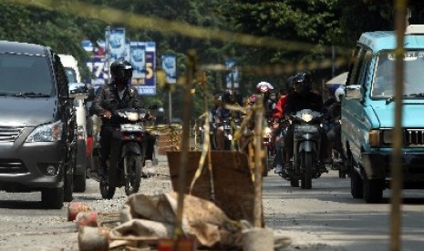   Kendaraan melintasi proyek betonisasi Jalan KH Noer Ali, Bekasi, Jawa Barat