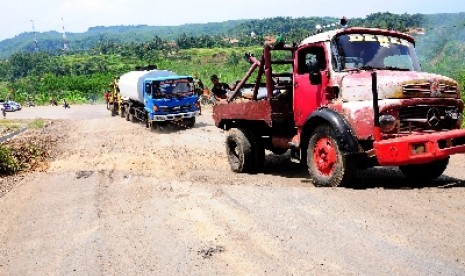  Kendaraan menderek truk yang tidak kuat naik saat melintasi jalan amblas di jalur Ciregol, Brebes, Jateng, Rabu (7/3). Jalur utama jurusan Tegal - Purwokerto kembali amblas sedalam 30 - 40 Cm dan panjang 9 meter, akibat pergerakan tanah yang labil