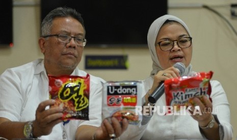 Kepala Badan Pengawan Obat dan Makanan (BPOM) Penny Kusumastuti Lukito (kanan) bersama Deputi Bidang Pengawasan Keamanan Pangan dan Bahan Berbahaya Suratmono (kiri) menunjukan mie yang mengandung minyak babi saat menggelar konferensi pers di Pelabuhan Tanjung Priok, Jakarta Utara, Senin (19/6).