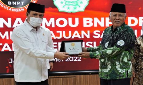 Kepala BNPT Komjen Pol. Boy Rafli Amar (kiri) bersama Ketum IPI KH K M T Abdul Muhaimin memberikan plakat usai penandatanganan kerja sama. Peran pesantren dalam wujudkan toleransi beragama dinilai penting.