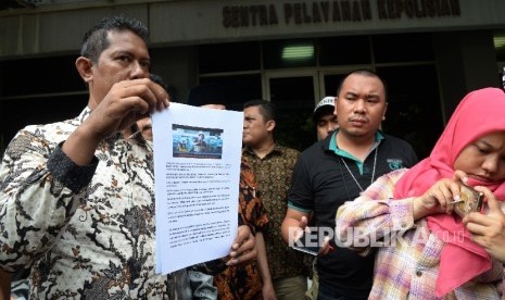 Ketua Forum Anti Penistaan Agama (FUPA) Syamsu Hilal Chaniago menunjukkan bukti gambar untuk melaporkan Basuki Tjahaja Purnama atau Ahok terkait dugaan penistaan agama saat datang di SPKT Polda Metro Jaya, Jakarta. 