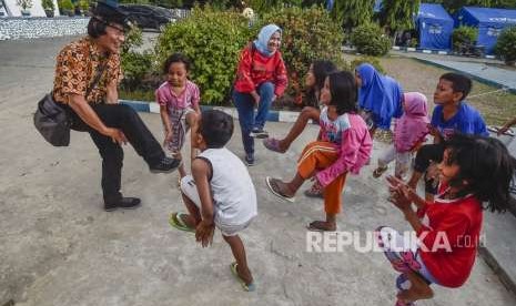 Ketua KPAI Seto Mulyadi atau Kak Seto melakukan Trauma Healing dengan cara mengajak bermain anak-anak korban gempa tsunami Palu di kantor Dinas Sosial, Palu, Sulawesi Tengah, Jumat (5/10).