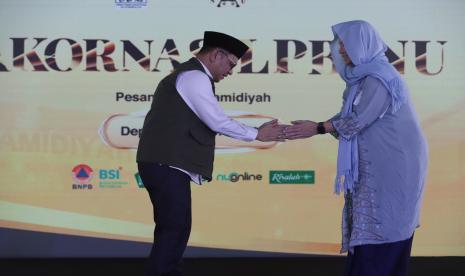 Ketua PP LPBI NU Tb Ace Hasan Syadzili menyalami COO Danone Indonesia Connie Ang.