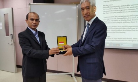   Ketua Umum Aspikom Dr Heri Budianto menyerahkan cenderamata kepada Prof Sung Kyum Cho, president of Korean Society for Journalism an Communication Studies.