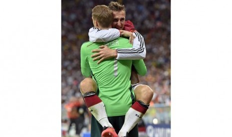 Kiper Jerman Manuel Neuer merayakan dengan Miroslav Klose setelah Jerman Mario Goetze mencetak gol pembuka selama Piala Dunia pertandingan sepak bola final antara Jerman dan Argentina di Stadion Maracana di Rio de Janeiro, Brasil, Minggu (13/7). (AP/Martin