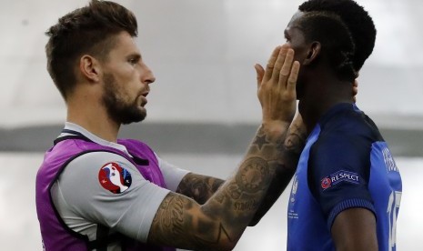 Kiper timnas Prancis, Benoit Costil (kiri) bersama Paul Pogba seusai laga final Piala Eropa 2016 lawan Portugal, Juli 2016.