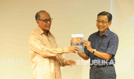 Komisaris Utama Kelompok Penerbit Mizan Abdillah Toha (kiri) memberikan buku 