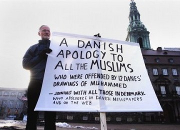 Seorang warga Denmark mengangkat poster bertuliskan permintaan maaf terhadap komunitas Muslim atas pemuatan karikatur Nabi Muhammad SAW di sebuah koran Denmark, beberapa waktu lalu.