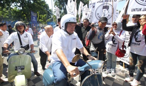 La Nyalla Mattalitti (tengah) mengendarai Vespa menuju kantor DPD Partai Demokrat Jatim di Jalan Raya Kertajaya Surabaya, Jawa Timur, Senin (17/7). 