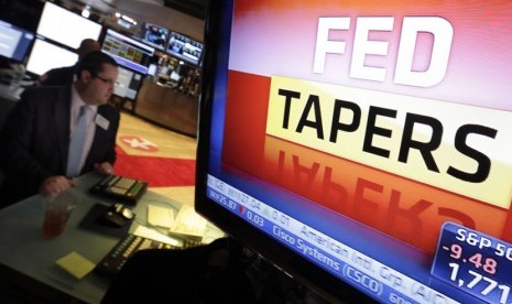 Layar TV di lantai Bursa New York, berisi pengumuman kebijakan Bank sentral AS atau The Federal Reserve (Fed) pada Rabu (18/12). 