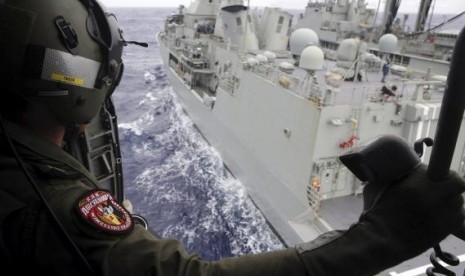 Leading Seaman Aircrewman Joel Young looks out from Tiger75, an S-70B-2 Seahawk helicopter, in the southern Indian Ocean for the missing Malaysian Airlines flight MH370. 