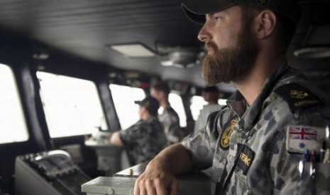 Leading Seaman Luke Horsburgh stands during his duty as Quartermaster on the bridge of the Australian Navy ship HMAS Success in the search area for missing Malaysian Airlines flight MH370 (picture is released by the Australian Defence Force on March 23, 20