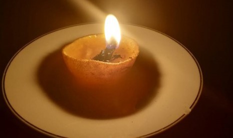 Lilin dari kulit jeruk dan gelas digunakan warga Kota Bandung saat listrik PLN mati.