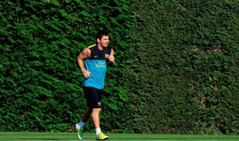 Lionel Messi saat latihan perdana Barcelona menghadapi musim baru 2012/2013