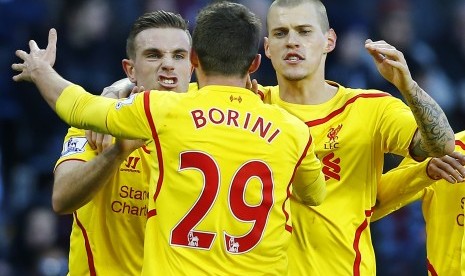 Liverpool's Fabio Borini celebrates his goal against Aston Villa with Jordan Henderson (L) and Martin Skrtel (R) during their English Premier League soccer match at Villa Park in Birmingham, central England, January 17, 2015.