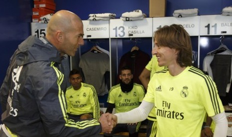 Luka Modric berjabat tangan dengan pelatih Zinedine Zidane.