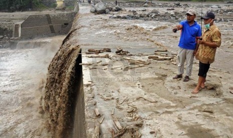 Warga menyaksikan aliran lahar dingin di tanggul Waduk Siman, Kabupaten Kediri, Jawa Timur, Rabu (19/2).  (Republika/Adhi Wicaksono)