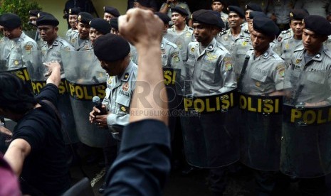  Petugas kepolisian menghalau para demonstran yang memaksa masuk ke kantor KPU saat simulasi pemilu di depan kantor KPU Jakarta Selatan, Jumat (21/2). (Republika/Agung Supriyanto)