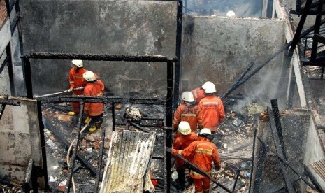 Sejumlah petugas pemadam kebakaran berusaha memadamkan api saat kebakaran terjadi di Jalan Kelinci 3, Pasar Baru, Jakarta Pusat, Selasa (25/2).  (foto : Raisan Al Farisi)