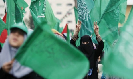 Puluhan ribu warga Gaza menyanyikan slogan-slogan saat memperingati ulang tahun ke-10 wafatnya pemimpin spiritual Hamas Syekh Ahmed Yassin di Gaza, Ahad (23/3). (AP/Hatem Moussa)