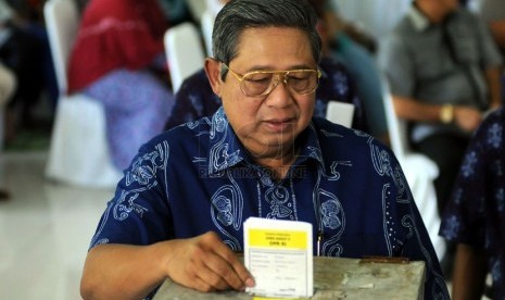  Presiden Susilo Bambang Yudhoyono memasukkan surat suara yang telah mereka coblos di Tempat Pemungutan Suara (TPS) 006, Desa Nagrak, Kecamatan Gunung Putri, Kabupaten Bogor, Rabu (9/4).  (Republika/Aditya Pradana Putra)