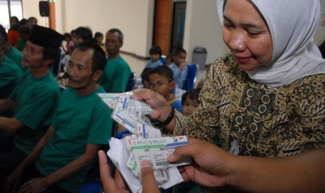  Petugas membagikan kartu BPJS kesehatan kepada warga   di Panti Sosial Bina Insan Bangun Daya 2, Cipayung, Jakarta Timur, Kamis (24/4). (Republika/Rakhmawaty La'lang)