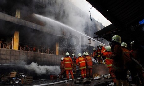 Petugas pemadam kebakaran berusaha untuk memadamkan api yang melalap sejumlah kios di Pasar Senen, Jakarta Pusat, Jumat (25/4). (Republika/Rakhmawaty La'lang)