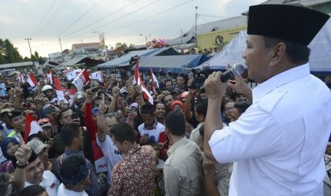   Capres Prabowo Subianto menyampaikan orasi saat mengunjungi pasar Ciparay, Bandung, Jabar, Kamis (3/7). (Antara/Prasetyo Utomo)