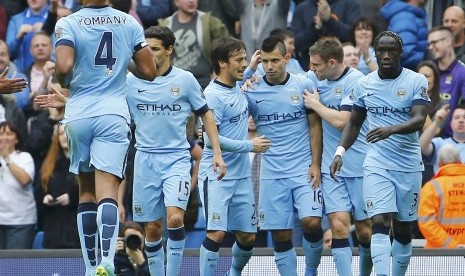 Manchester City's Sergio Aguero (3rd R) celebrates with team-mates after scoring a penalty during their English Premier League soccer match against Tottenham Hotspur at the Etihad Stadium in Manchester, northern England October 18, 2014.