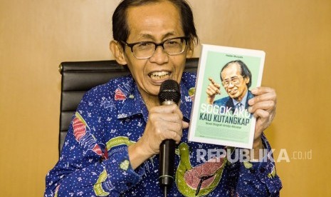 Mantan Hakim Agung Kamar Pidana Mahkamah Agung (MA), Artidjo Alkostar menunjukkan buku tentang dirinya saat konferensi pers di Media Center Mahkamah Agung, Jakarta, Jumat (25/5). 