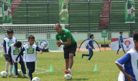 Mantan striker timnas Indonesia,  Kurniawan Dwi Yulianto sedang memberikan pelatihan pada peserta Milo Football Championship,  di Stadion Siliwangi Bandung, Sabtu (14/4).