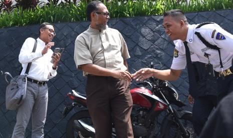 Mantan Wakil Ketua KPK Bambang Widjojanto (tengah) bersalaman dengan petugas keamanan KPK seusai mengunjungi Gedung KPK, Jakarta, Jumat (4/3).