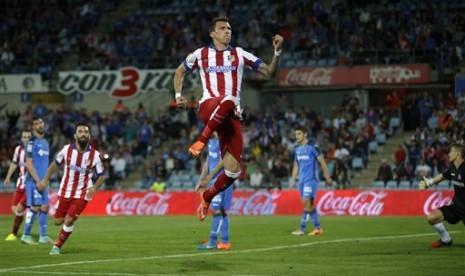 Mario Mandzukic merayakan golnya ke gawang Getafe, Senin (27/10).