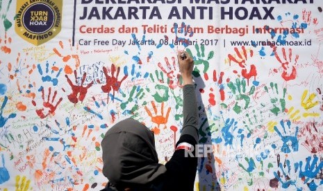  Masyarakat membubuhkan tanda tangan saat kegiatan sosialisasi sekaligus deklarasi masyarakat anti hoax di Jakarta,Ahad (8/1). 