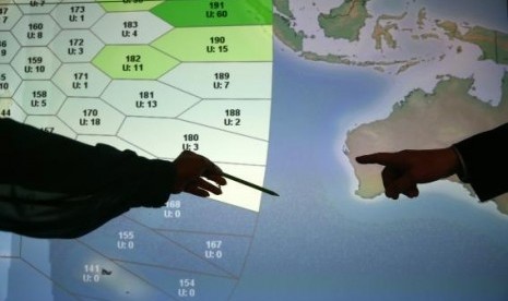 Member of staff at satellite communications company Inmarsat point to a section of the screen showing the southern Indian Ocean to the west of Australia, at their headquarters in London March 25, 2014.