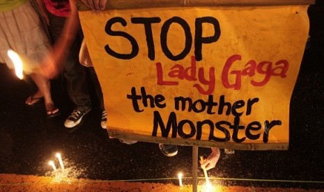 Members of a religious group light candles during a protest against the concert of pop star Lady Gaga near the venue in suburban Pasay, south of Manila, Philippines on Monday. Authorities in the conservative, majority Roman Catholic country approved the co