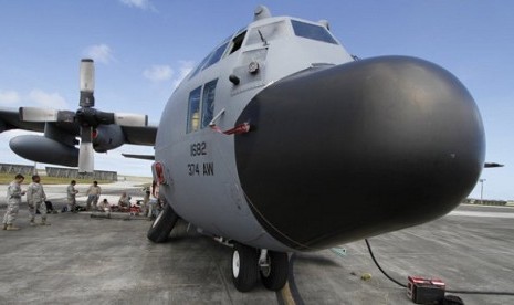 Members of the 374th Airlift Wing of US Air Force work on a C-130 aircraft during the Cope North military exercises at Andersen US Air Force Base in Guam Thursday, Feb. 7, 2013. 