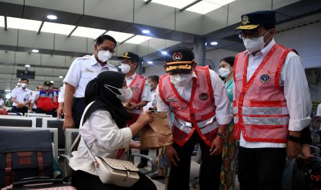 Menko PMK Muhadjir Effendy (kedua kanan), Menhub Budi Karya Sumadi (kanan) serta Dirut PT Kereta Api Indonesia (Persero) Didiek Hartantyo (kiri) berbincang dengan calon penumpang kereta api di Stasiun Pasar Senen, Jakarta Pusat, Kamis (7/4/2022). Menko PMK Muhadjir Effendy dan Menhub Budi Karya Sumadi meninjau kesiapan angkutan mudik Lebaran 2022 di stasiun tersebut. 