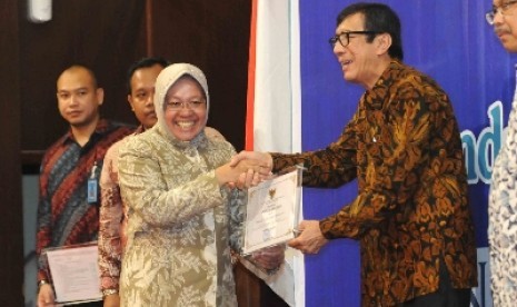 Menteri Hukum dan HAM Yasonna Laoly memberi piagam kepada Wali Kota Surabaya, Tri Rismaharini.