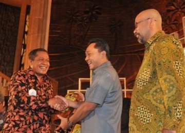 Menteri Kehutanan Zulkifli Hasan (tengah) memberi penghargaan kepada Bupati Wakatobi Hugua (kiri) disaksikan Pendiri La Tofi School of Corporate Social Responsibility (CSR) La Tofi (kanan) dalam Indonesia Green Awards 2011 di Jakarta, Rabu (28/9). 