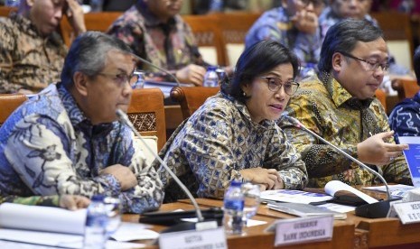 Menteri Keuangan Sri Mulyani (tengah) bersama Menteri PPN/Kepala Bappenas Bambang Brodjonegoro (kanan) dan Gubernur Bank Indonesia (BI) Perry Warjiyo (kiri) mengikuti rapat kerja dengan Komisi XI DPR di Kompleks Parlemen, Senayan, Jakarta, Kamis (13/6/2019).