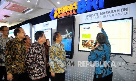 Menteri Komunikasi dan Informatika Rudiantara (kedua Kanan) serta Direktur Utama Bank BRI Asmawi Syam (kedua kiri) melihat aplikasi digital.