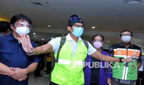 Menteri Pariwisata dan Ekonomi Kreatif (Menparekraf) Sandiaga Uno (kedua kiri) didampingi Direktur Teknik PT Angkasa Pura I (Persero) Lukman F. Laisa (kiri) meninjau area Terminal Domestik Bandara Internasional I Gusti Ngurah Rai, Badung, Bali, Ahad (27/12/2020). Dalam kunjungan kerja pertamanya tersebut, Menparekraf meninjau dan memastikan penerapan protokol kesehatan pencegahan COVID-19 bagi para wisatawan yang tiba di Pulau Dewata melalui Bandara Ngurah Rai. 