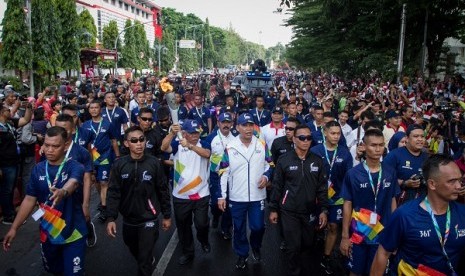 Menteri Pekerjaan Umum dan Perumahan Rakyat Basuki Hadimuljono membawa obor saat kirab obor Asian Games 2018 di Solo, Kamis (19/7). 