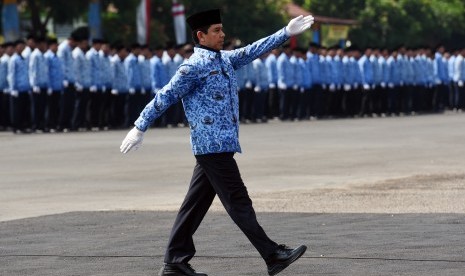 Menteri Pemberdayaan Aparatur Negara dan Reformasi Birokrasi Yuddy Chrisnandi (kiri) mengikuti Upacara peringatan HUT ke-44 Korps Pegawai Republik Indonesia (Korpri) sebagai Inspektur upacara di Lapangan Makodam V/Brawijaya Surabaya, Jawa Timur, Senin (30/