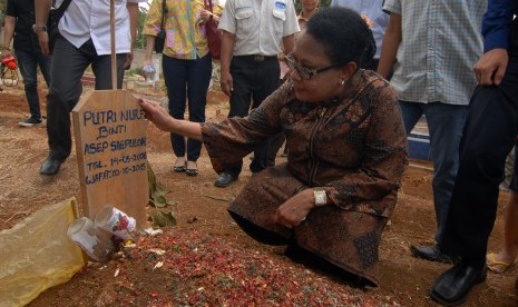 Menteri Pemberdayaan Perempuan dan Perlindungan Anak Yohana Yembise berdoa di makam Putri Nur Fauziah seorang anak korban pembunuhan disertai tindak kejahatan asusila, di Kalideres, Jakarta Barat, Rabu (7/10).