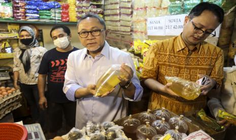 Menteri Perdagangan Zulkifli Hasan (Kedua kanan) didampingi Wakil Menteri Jerry Sambuaga (kanan) meninjau harga minyak goreng curah di Pasar Cibubur, Jakarta, Kamis (16/6/2022). Kunjungan tersebut dilakukan untuk melihat dan memantau langsung harga bahan pokok dan minyak goreng guna memastikan harga stabil menjelang Hari Raya Idul Adha 1443 Hijriah. 