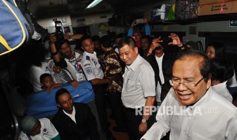 Menteri Perhubungan Ignatius Jonan (tengah), Menteri Koordinator Kemaritiman Rizal Ramli (kanan) berbincang dengan penumpang saat melepas keberangkatan pemudik gratis sepeda motor dengan kereta api di Stasiun Pasar Senen, Rabu (29/6).  (Republika/ Tahta Ai