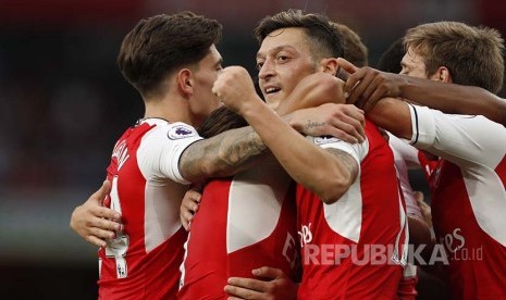 Mesut Oezil merayakan gol-nya saat melawan Chelsea, Ahad (26/9)